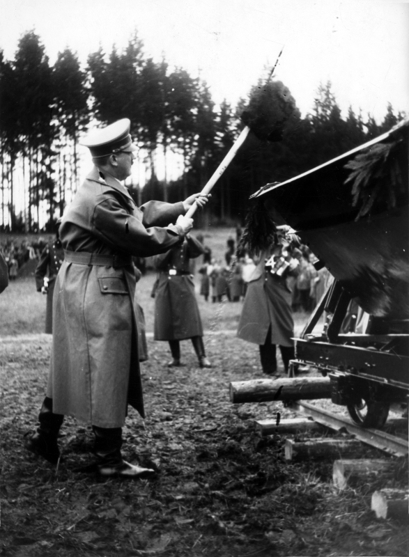 Adolf Hitler with a spade in front of decorated Lore in the groundbreaking ceremony of Reichsautobahn between Salzburg and Vienna